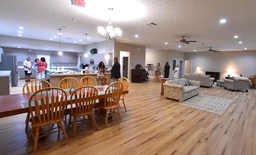 A large room with wooden floors and chairs.