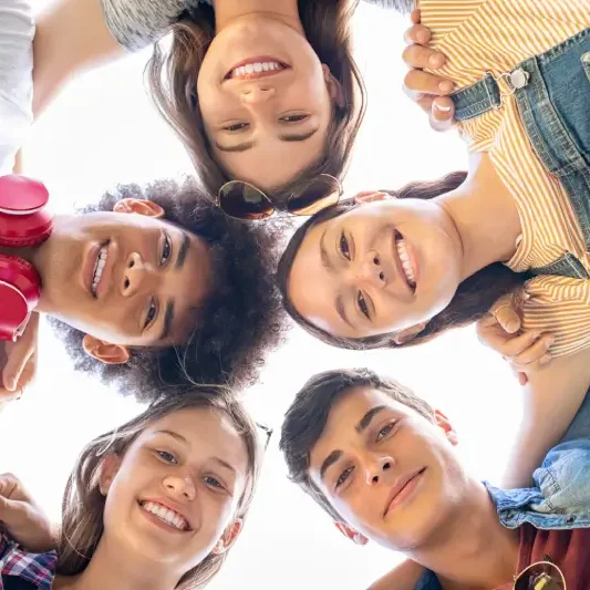 A group of young people standing in the middle of a circle.